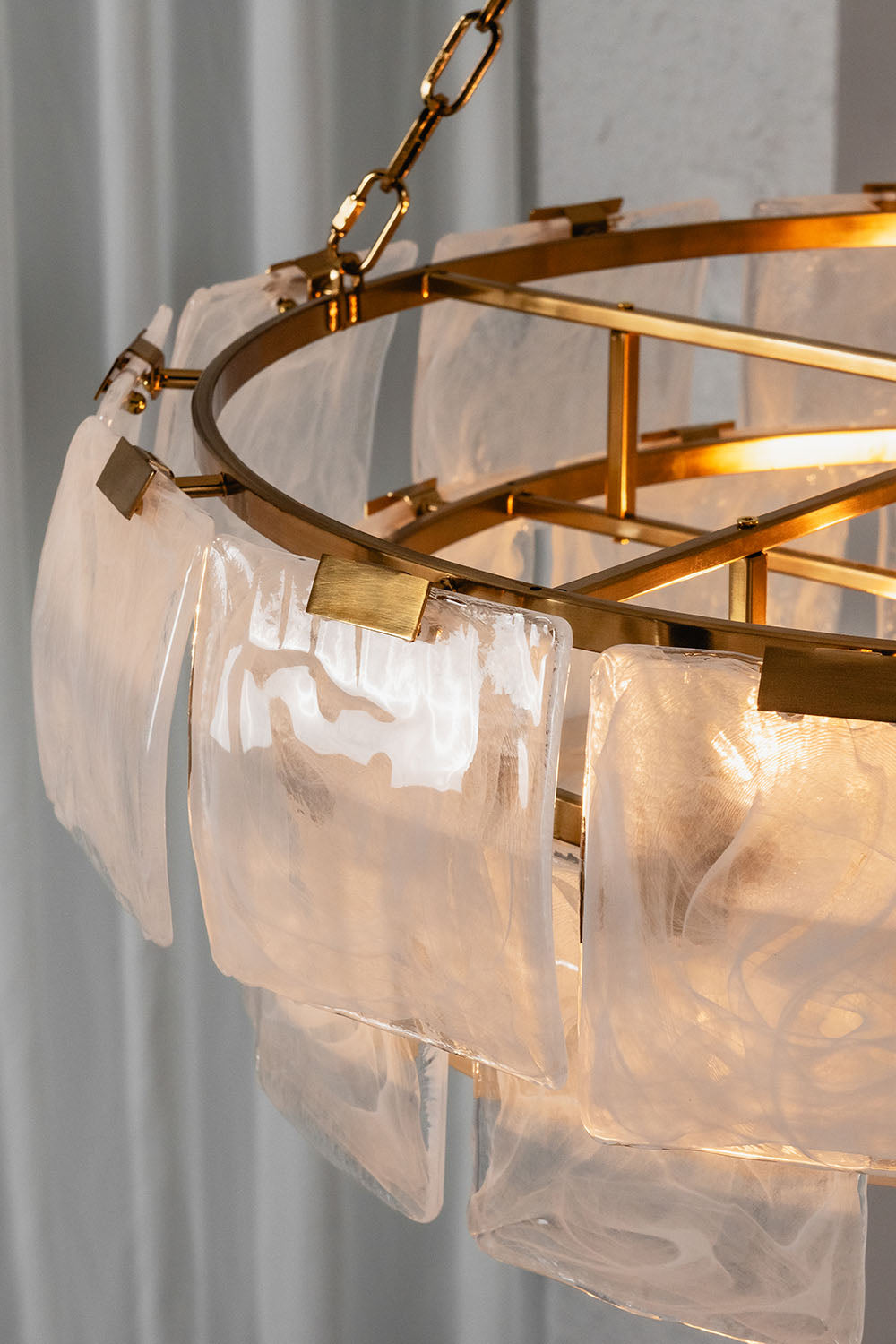 Verel Stepped Glass Drum Chandelier showcasing elegant glass pieces and a gold frame.