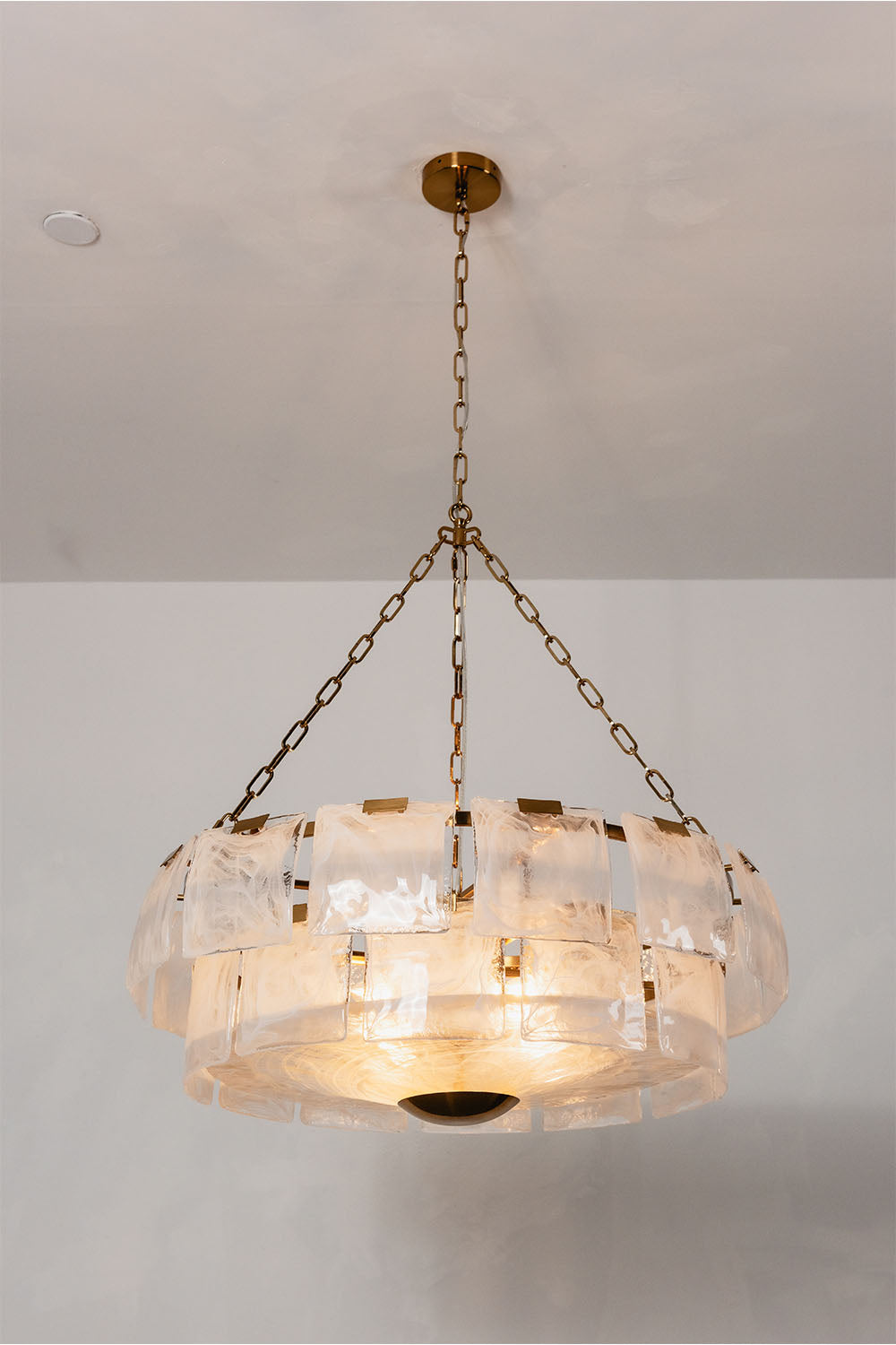 Verel Stepped Glass Drum Chandelier featuring elegant design and warm lighting for modern interiors.