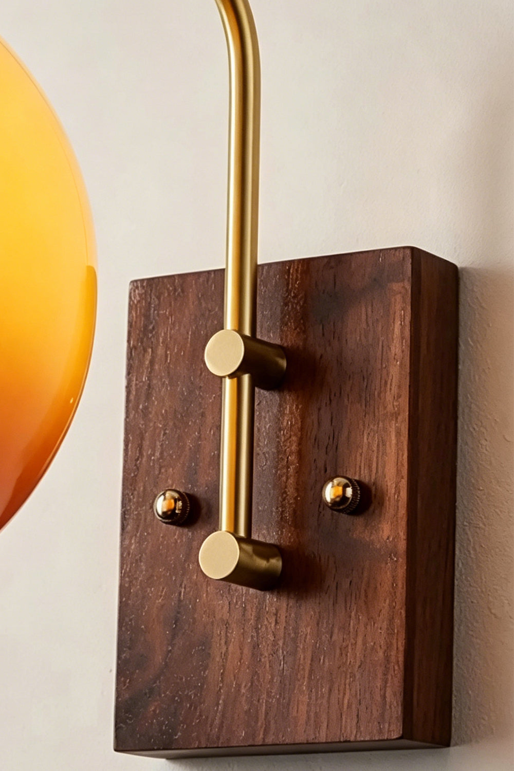 Vesper Caramel Gradient Wall Lamp | Glass, Metal, Wood | Close-up focus on the rich grain of the rectangular dark wood wall canopy and the brass mounting screws | Detail shot | Samu Lamp