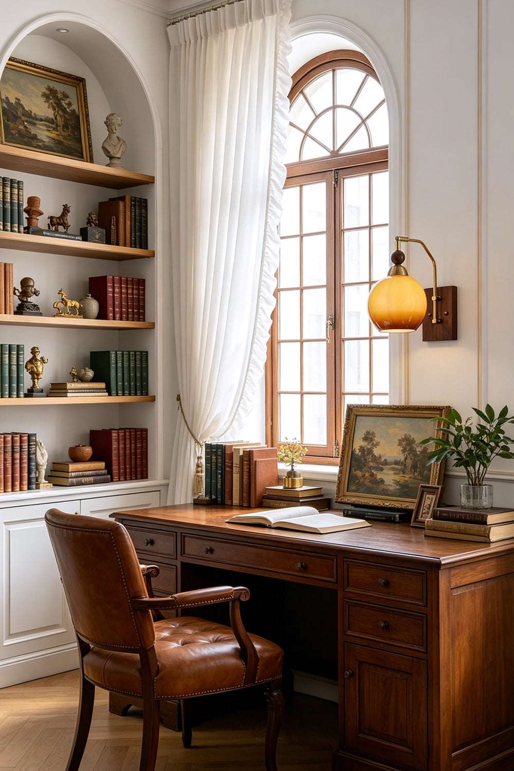 Vesper Caramel Gradient Wall Lamp | Glass, Metal, Wood | Providing a warm ambient glow on the wall of a traditional home office workspace with an executive desk and open bookshelves | Samu Lamp