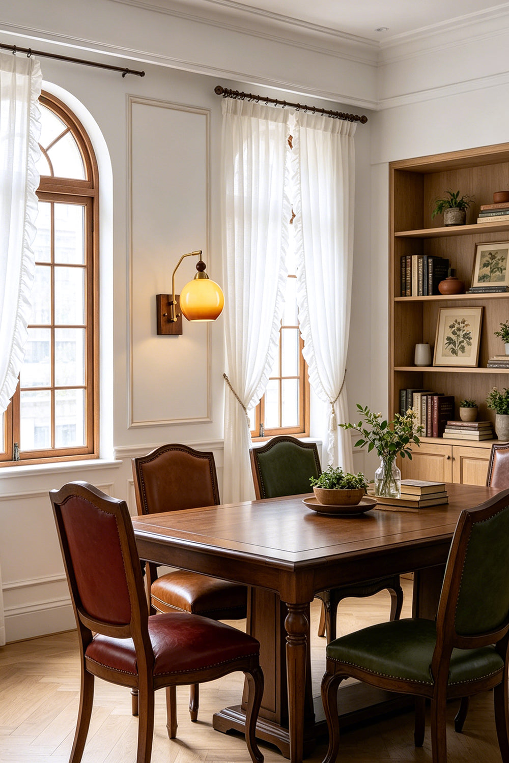 Vesper Caramel Gradient Wall Lamp | Glass, Metal, Wood | Installed as decorative accent lighting in an elegant classic dining room with a long wood table and leather chairs | Samu Lamp