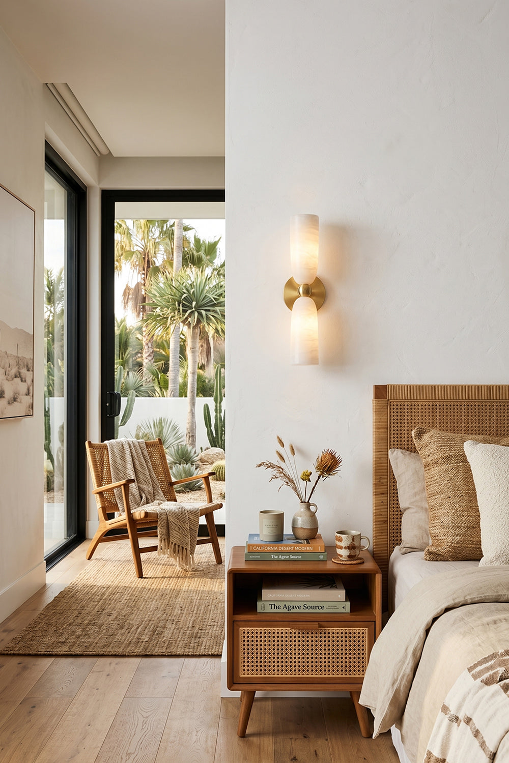 Vesperal Axis Alabaster Wall Lamp | Alabaster, Metal | Mounted as bedside lighting in a neutral-toned bedroom with rattan furniture | Samu Lamp