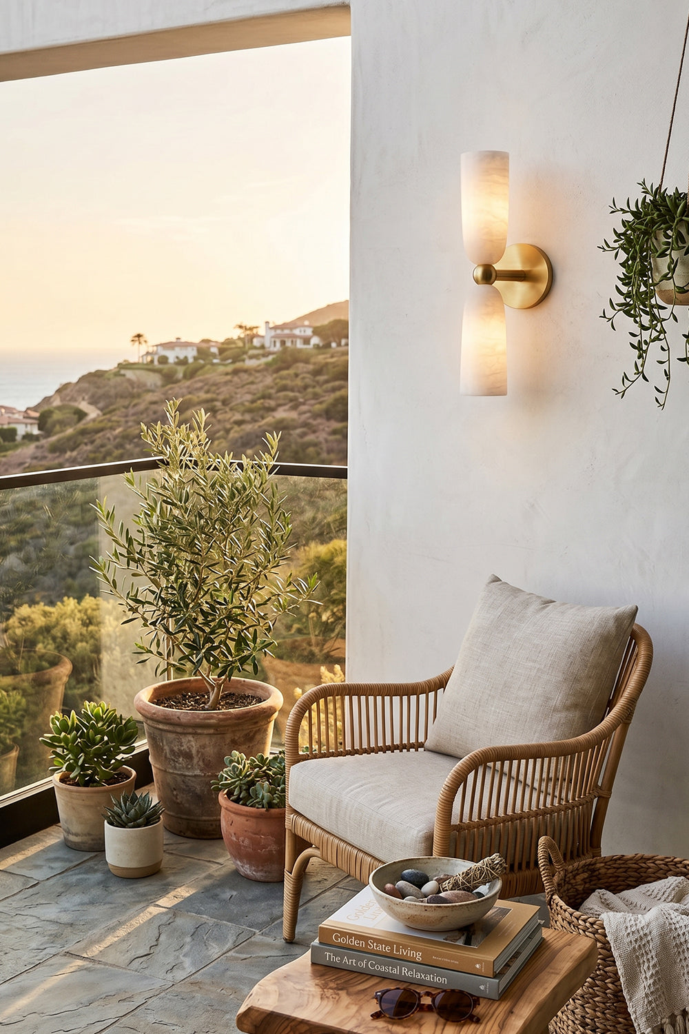 Vesperal Axis Alabaster Wall Lamp | Alabaster, Metal | Illuminating a scenic balcony at sunset with a rattan chair and potted plants | Samu Lamp