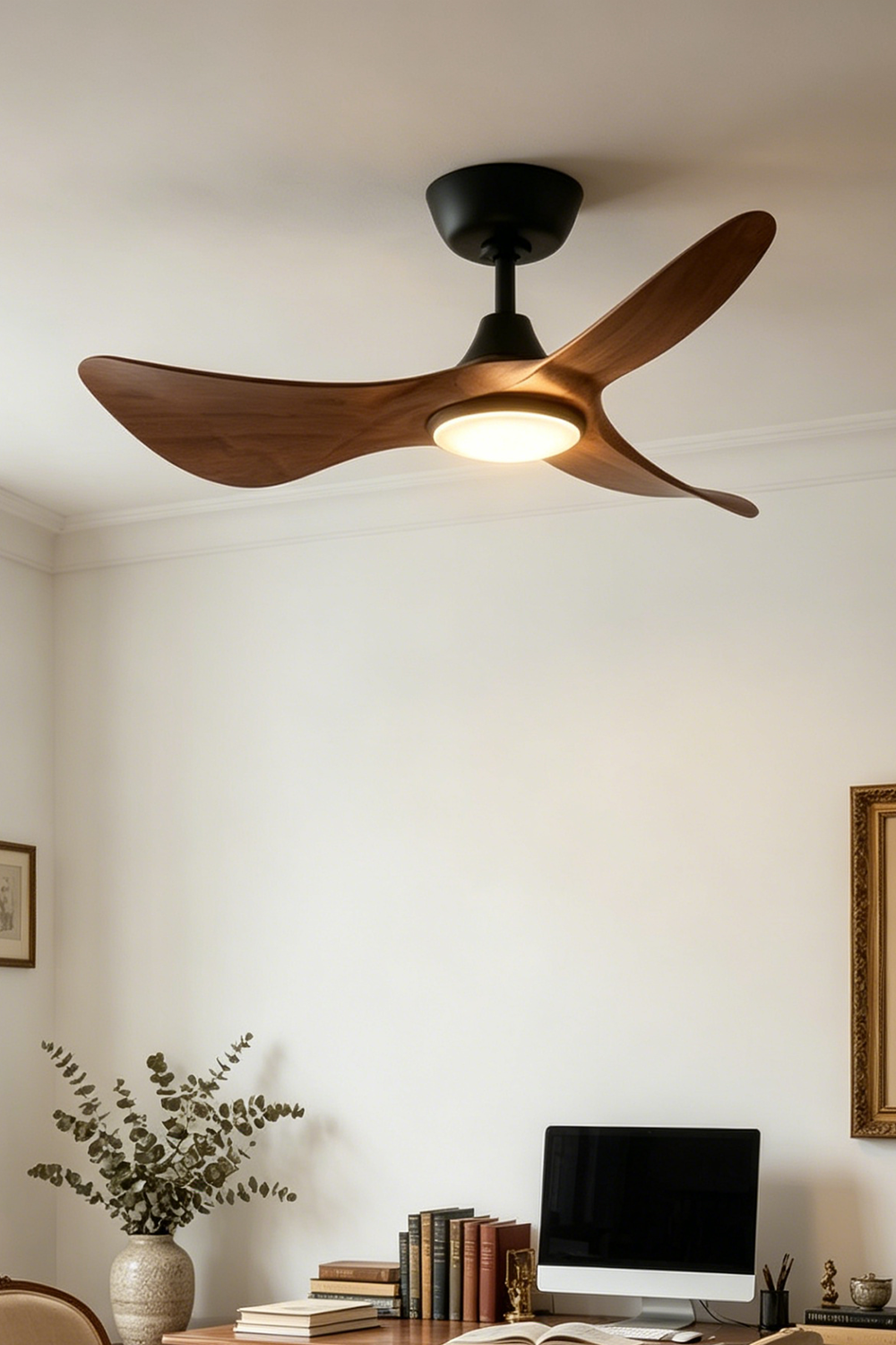 Volant Sculptural Wood Ceiling Fan Light | Wood, Metal | Angled view of the illuminated multi-blade chandelier fan fixture mounted flush against a white ceiling in a contemporary workspace | Samu Lamp