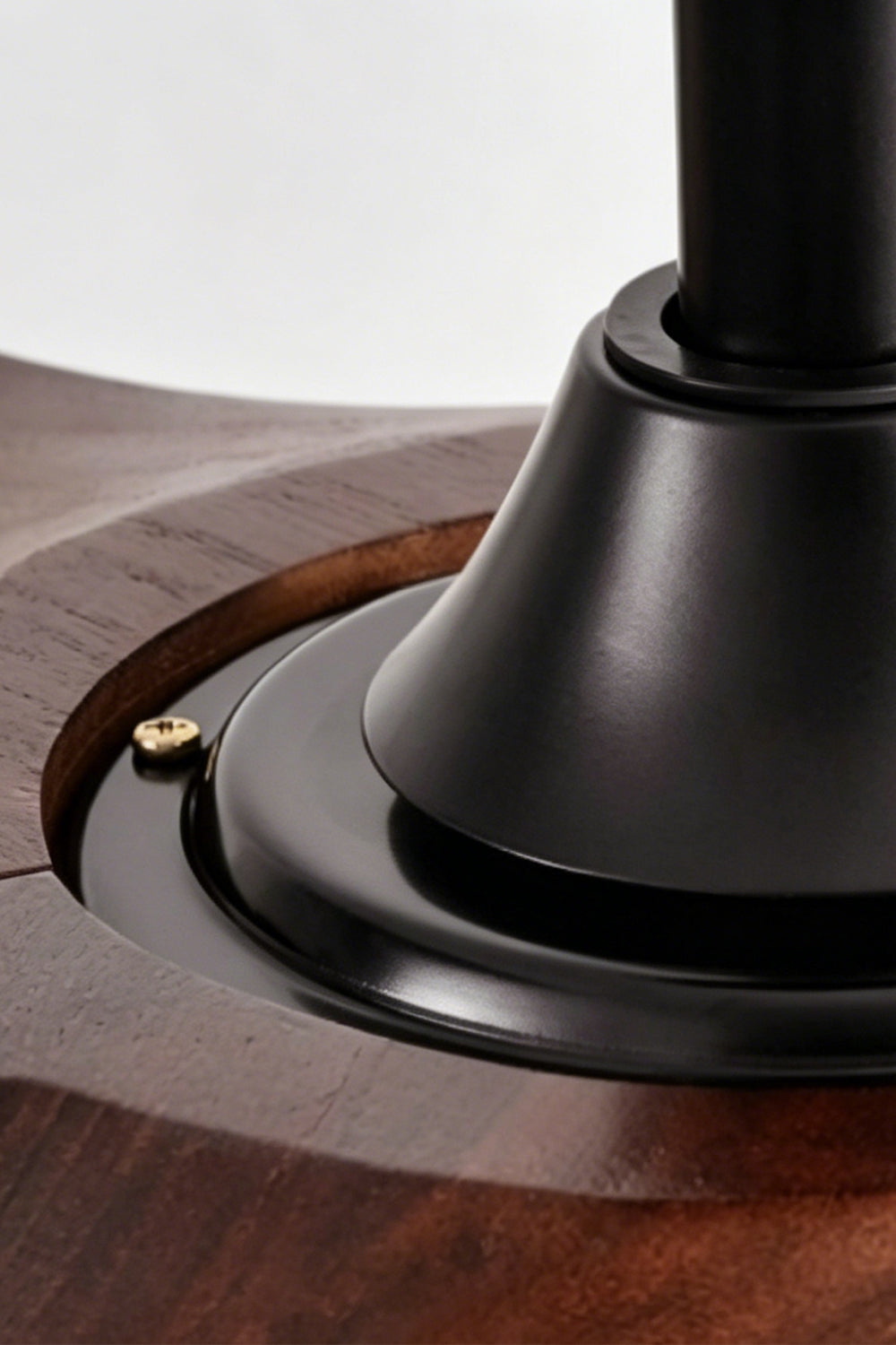 Volant Sculptural Wood Ceiling Fan Light | Wood, Metal | Detailed close-up showing the smooth integration of the walnut wood blades into the matte black metal cylindrical core housing | Detail shot | Samu Lamp