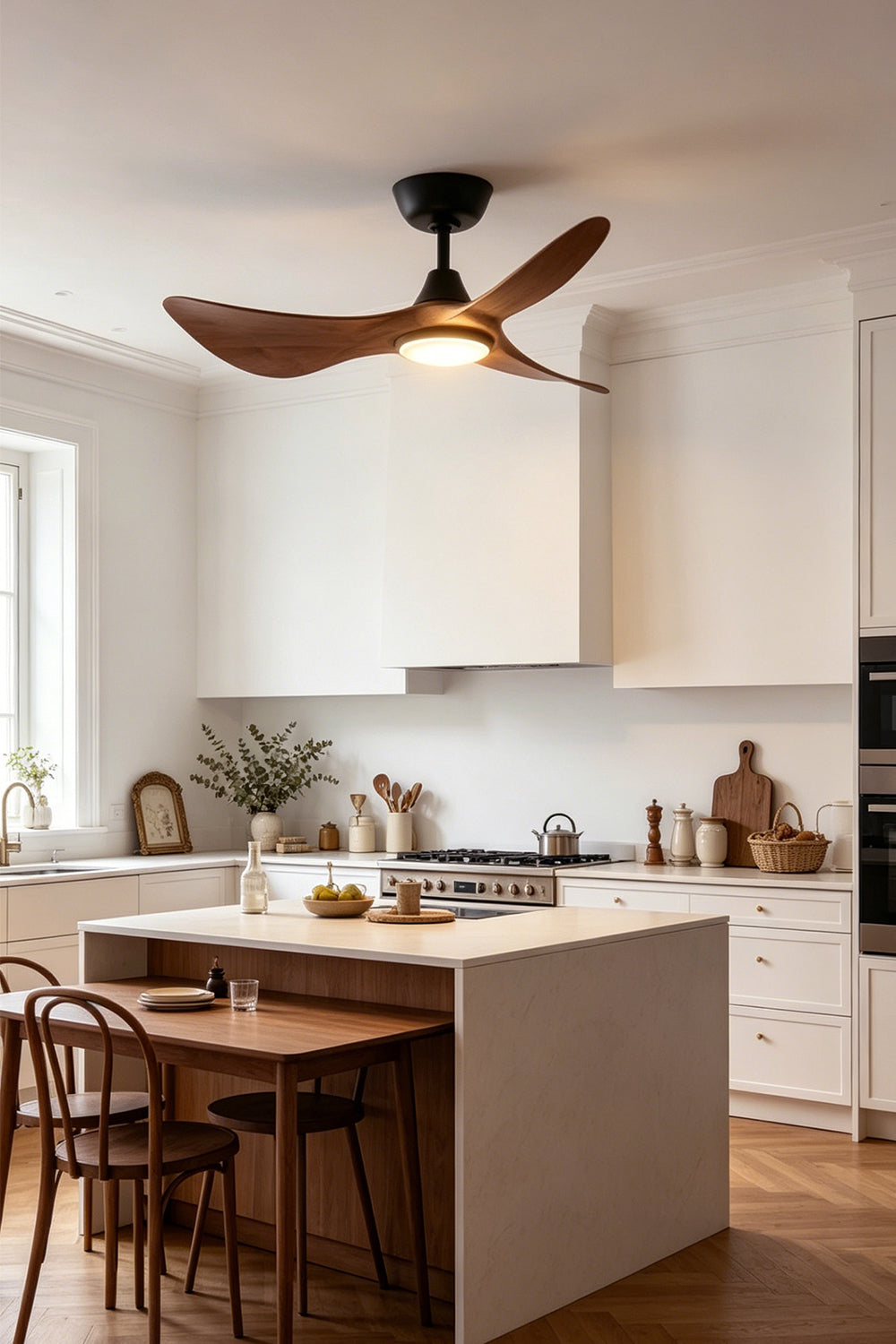 Volant Sculptural Wood Ceiling Fan Light | Wood, Metal | Positioned as sleek overhead lighting above a pristine white kitchen island counter with matching wooden bar stools | Samu Lamp