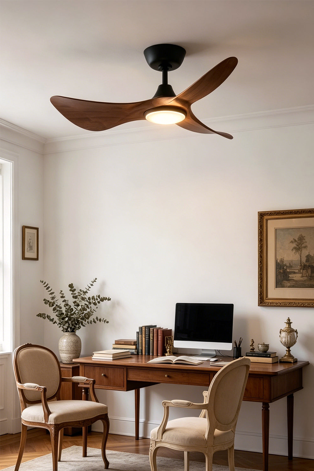Volant Sculptural Wood Ceiling Fan Light | Wood, Metal | Staged in a classic home study room, casting a warm glow over a dark wooden writing desk and elegant upholstered chair | Samu Lamp
