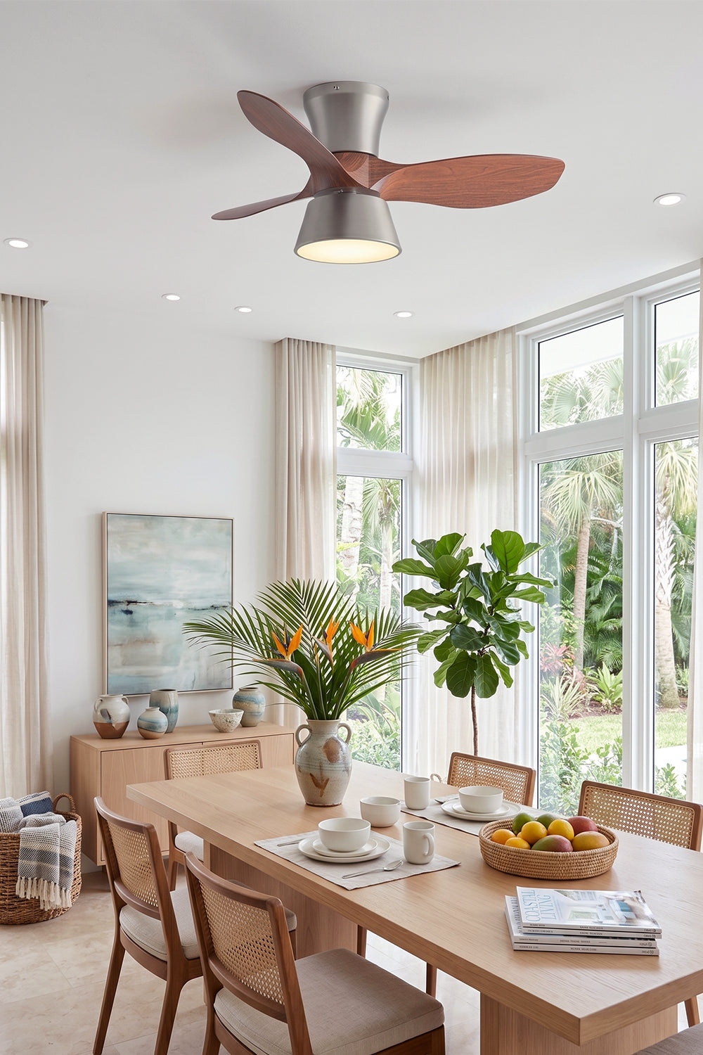 Volos Modern Minimalist Ceiling Fan Light | Wood, Metal | Installed as functional overhead lighting above a long wooden dining table set in a sunlit modern room with floor-to-ceiling garden windows | Samu Lamp