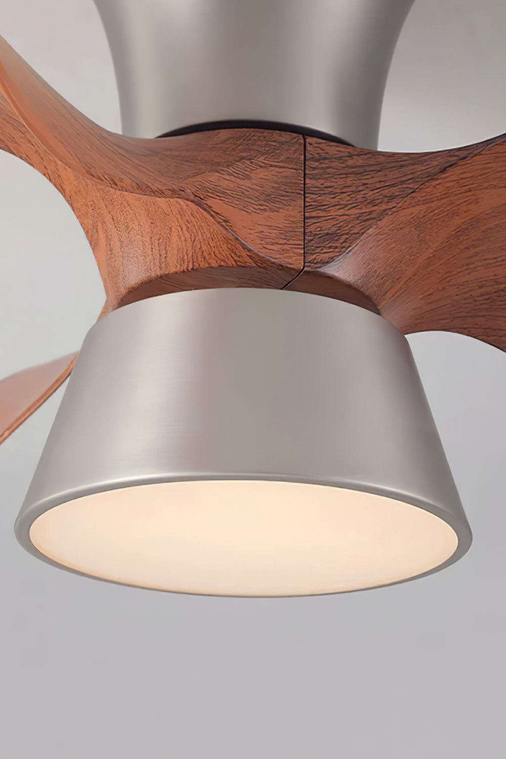 Volos Modern Minimalist Ceiling Fan Light | Wood, Metal | Close-up focus on the illuminated circular frosted glass diffuser dome and the brushed steel bottom metallic trim ring | Detail shot | Samu Lamp