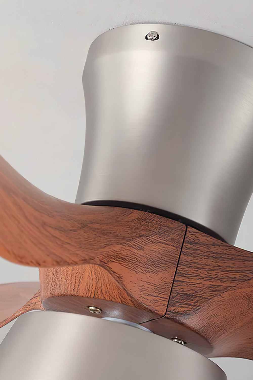 Volos Modern Minimalist Ceiling Fan Light | Wood, Metal | Detailed close-up showing the seamless integration of the carved wooden blades into the brushed nickel cylindrical motor housing | Detail shot | Samu Lamp