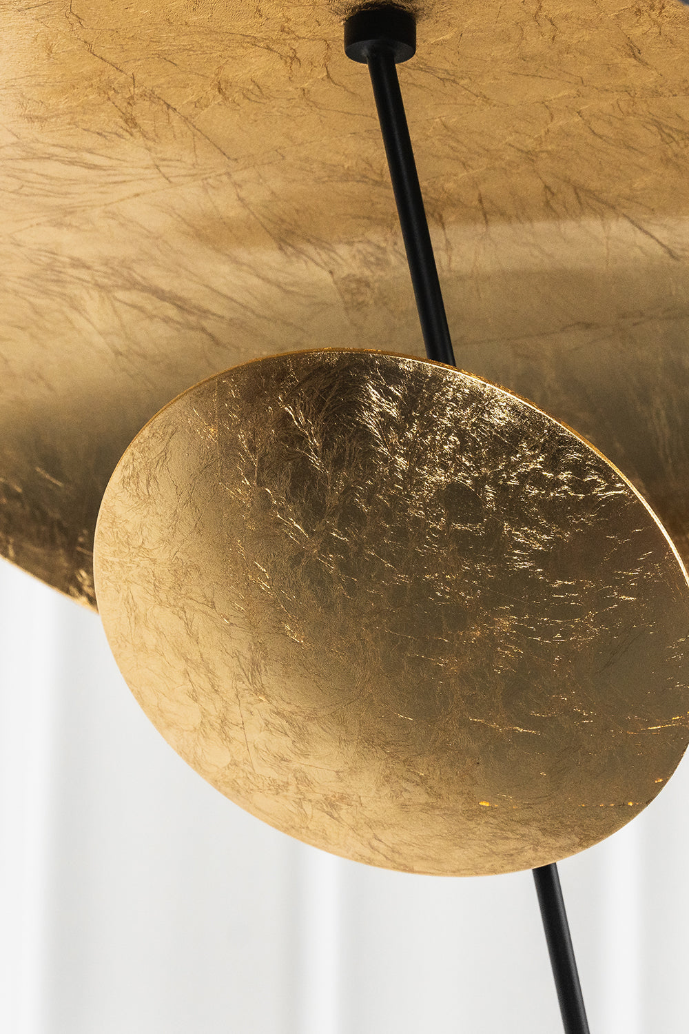 Voluta Horizon Metal Pendant Light | Metal | Macro focus on the textured gold foil surface of the lower decorative disc | Detail shot | Samu Lamp