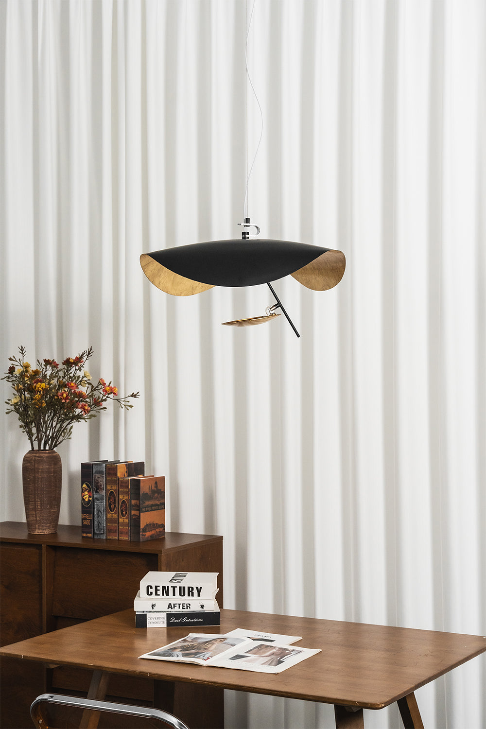 Voluta Horizon Metal Pendant Light | Metal | Frontal view of the unlit black pendant hanging in front of striped vertical blinds | Samu Lamp