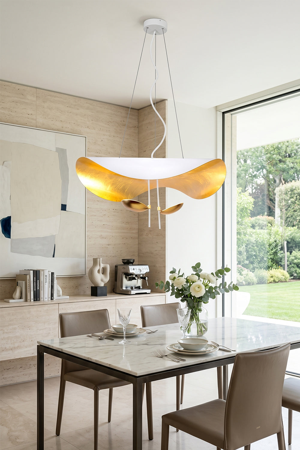 Voluta Horizon Metal Pendant Light | Metal | White and gold variant installed over a contemporary dining set in a bright room with large windows | Samu Lamp