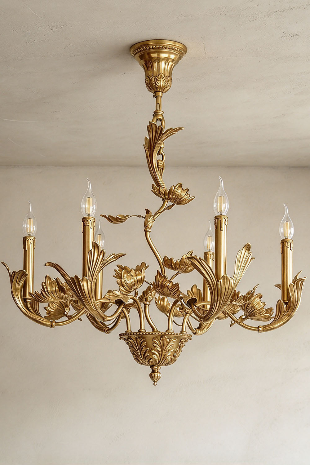 Vrilette Brass Leaf Vine Candle Chandelier | Carved Brass | Full product view glowing with warm candle light on a neutral background | Samu Lamp