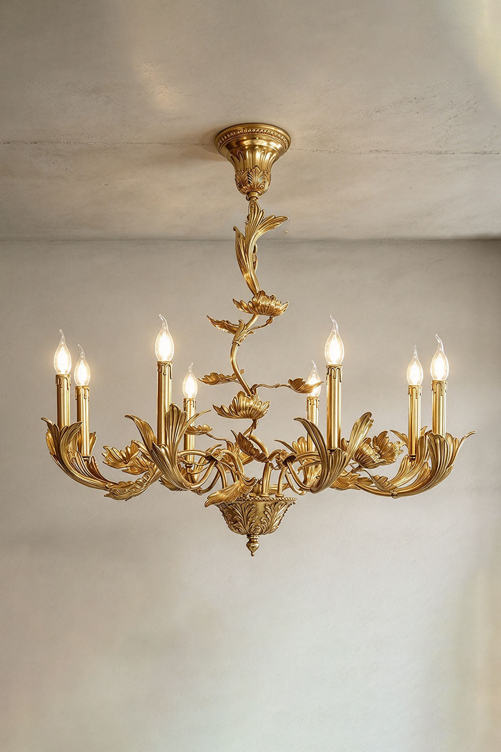Vrilette Brass Leaf Vine Candle Chandelier | Carved Brass | Front product view glowing brightly displayed against a plain background | Samu Lamp