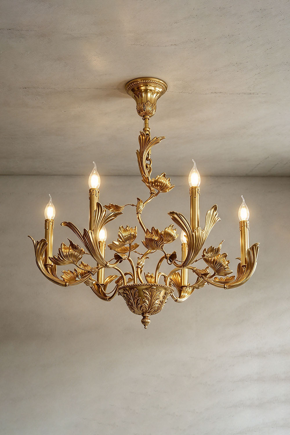Vrilette Brass Leaf Vine Candle Chandelier | Carved Brass | Studio product view illuminated gracefully against a plain studio wall | Samu Lamp