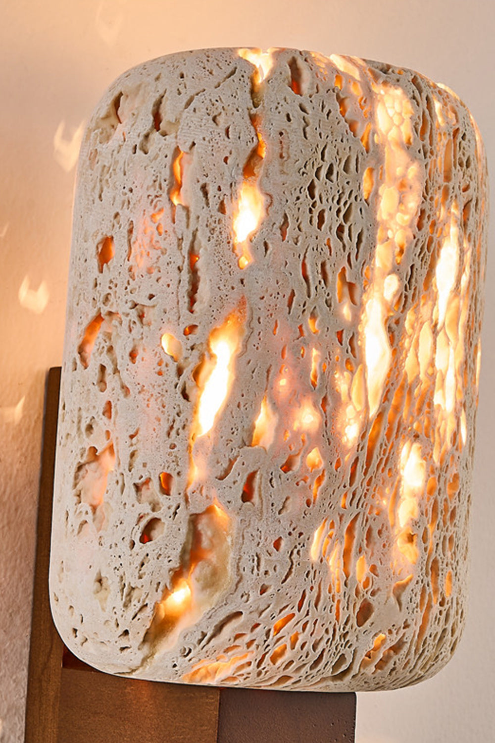 Detailed macro shot of glowing travertine stone | Travertine | Showing the natural pores and warm light diffusion | Samu Lamp