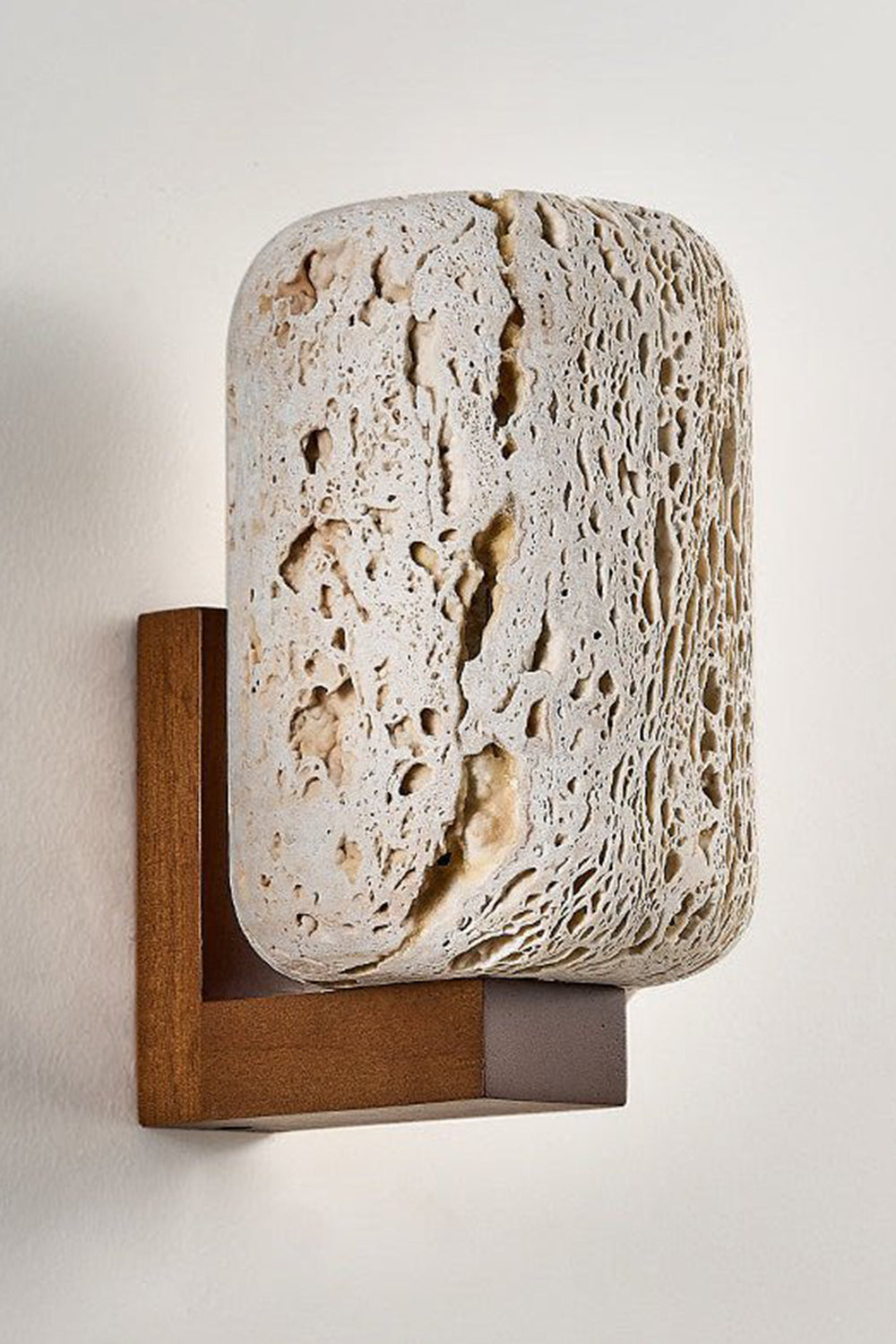 Unlit Wabi-Sabi travertine cylinder wall sconce | Travertine, Wood | Side perspective product view against a plain background | Samu Lamp