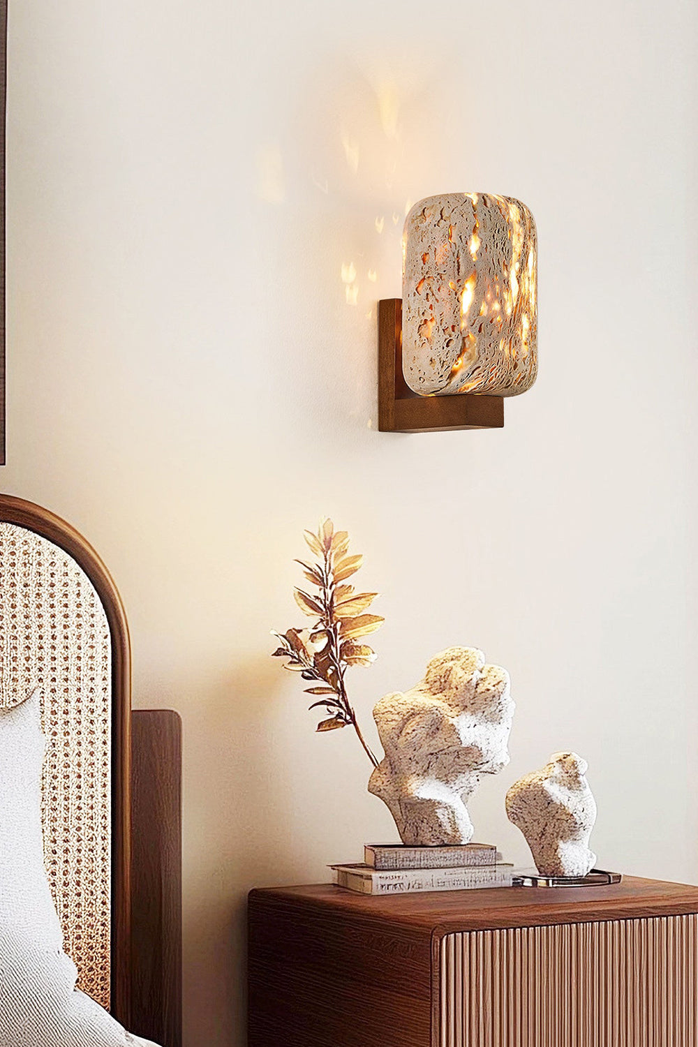 Lit travertine wall lamp in a cozy bedroom nook | Travertine, Wood | Installed near a rattan headboard and decor | Samu Lamp