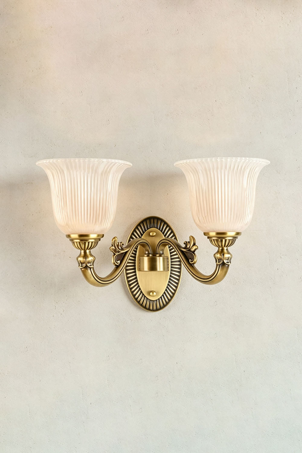 Whitlock Fluted Bell Brass Wall Lamp with two fluted glass shades and ornate brass fixture