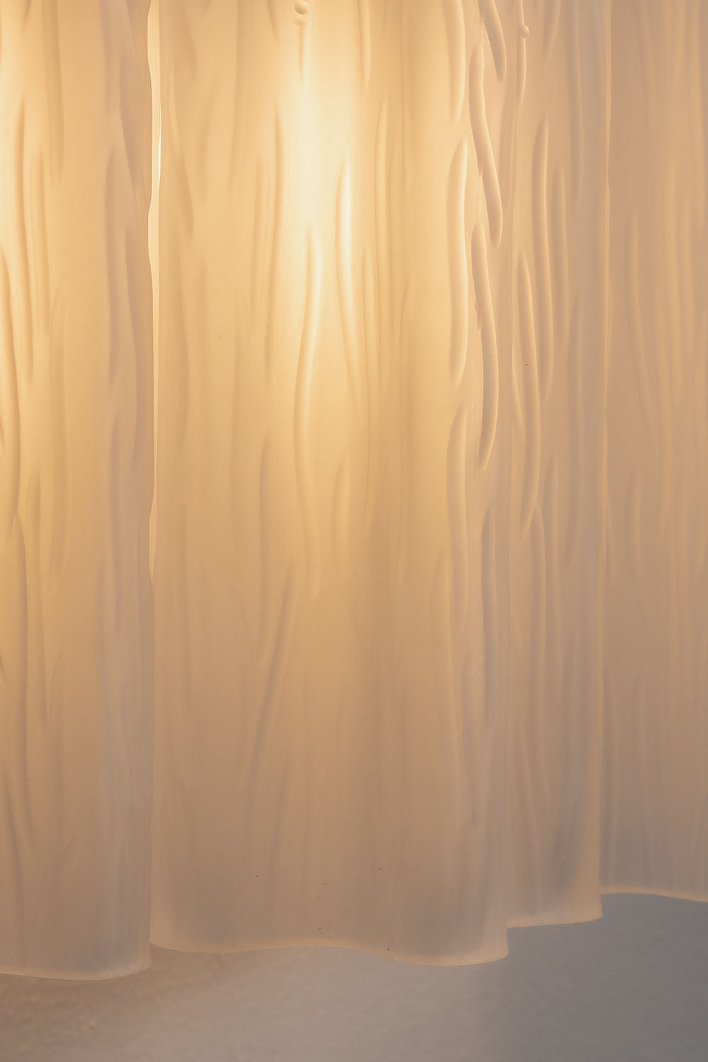 Ysoline Rippled Glass Curtain Sconce Light | Rippled Glass and Metal | Close-up detail of the warm glowing rippled glass texture | Samu Lamp