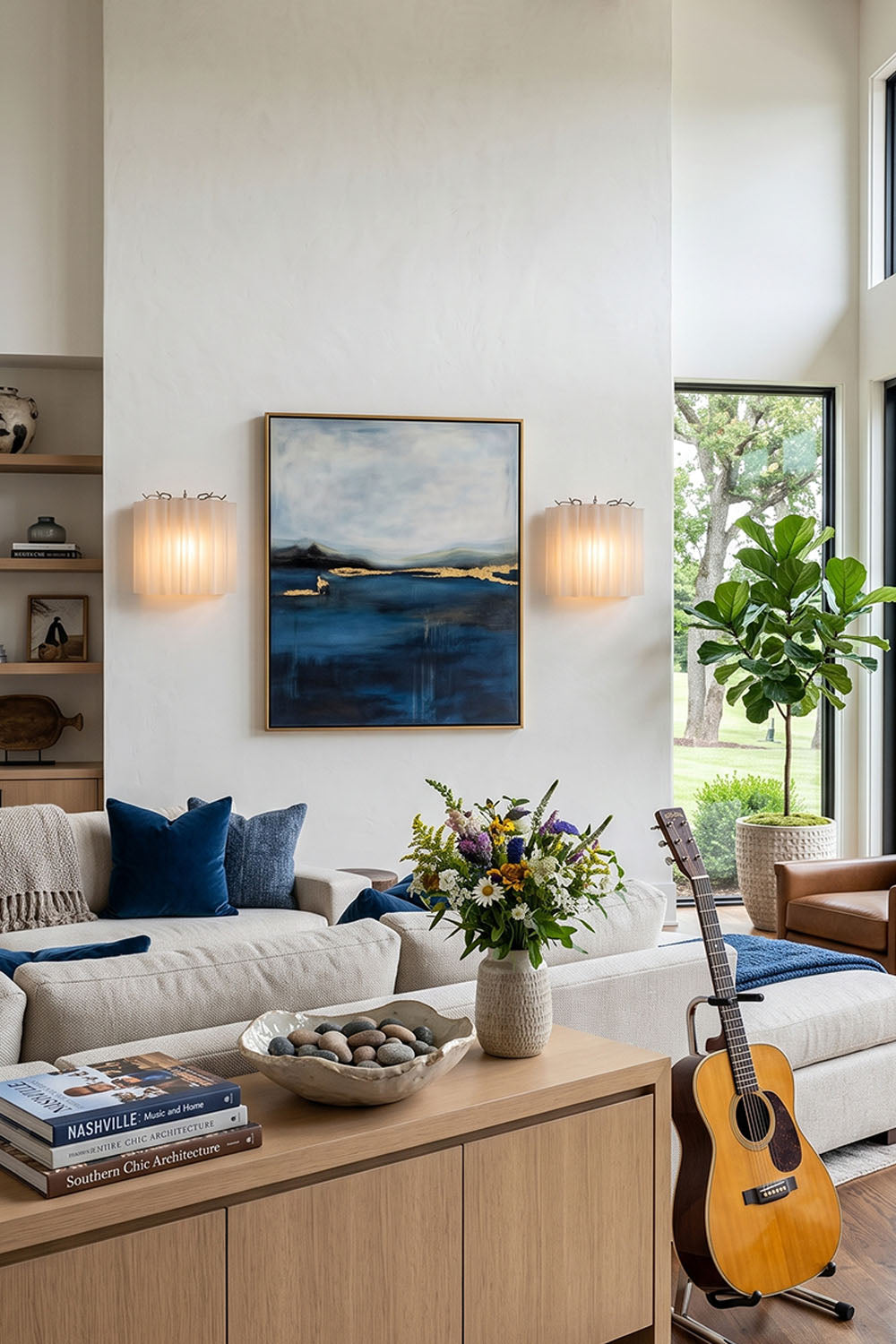 Ysoline Rippled Glass Curtain Sconce Light | Rippled Glass and Metal | Illuminating a living room wall beside blue artwork over a sofa | Samu Lamp